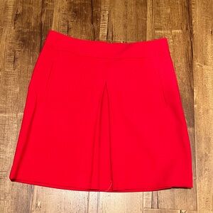LOFT red mini skirt with front pleat and slit pockets.  Size 10.